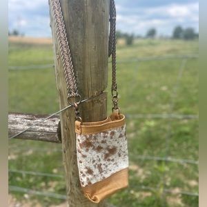 Tan cowhide bucket style crossbody